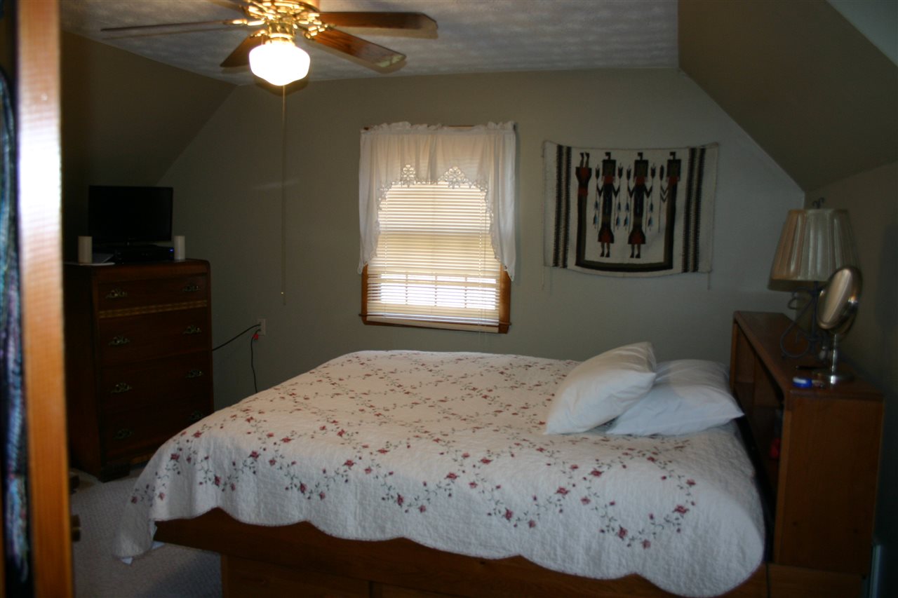 3335 Beulah Road Keezletown, VA 22832 - Photo 22 of 24 a bedroom with a bed and a chandelier