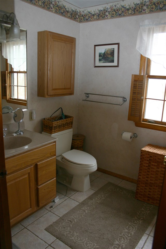 3335 Beulah Road Keezletown, VA 22832 - Photo 9 of 24 a bathroom with a toilet sink and mirror