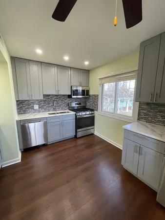 a kitchen with stainless steel appliances granite countertop a stove sink and cabinets
