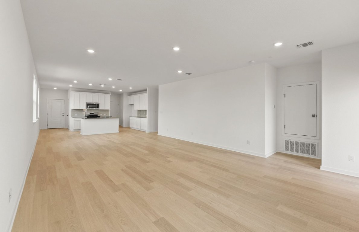 408 Sullivan Way Elgin, TX 78621 - Photo 10 of 22 a view of a kitchen with a refrigerator kitchen island and a sink