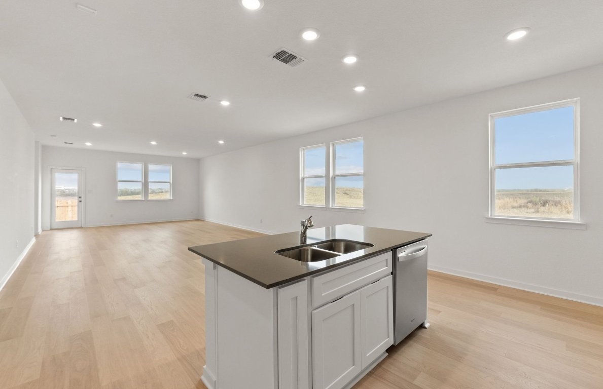 408 Sullivan Way Elgin, TX 78621 - Photo 6 of 22 a kitchen that has a sink and a stove top oven