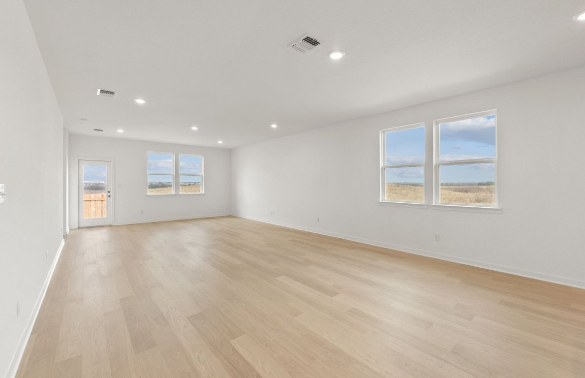 408 Sullivan Way Elgin, TX 78621 - Photo 9 of 22 wooden floor in an empty room with a window