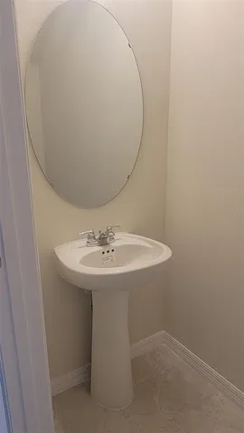a bathroom with a sink and mirror