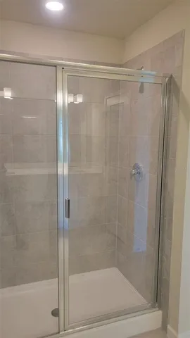 a bathroom with a glass shower door