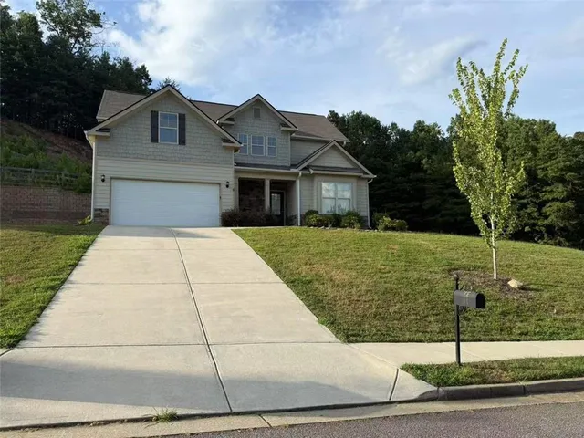 a front view of a house with yard