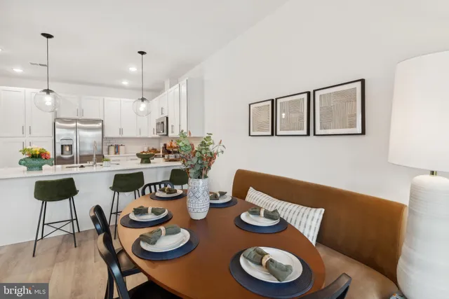 a kitchen with a dining table and chairs
