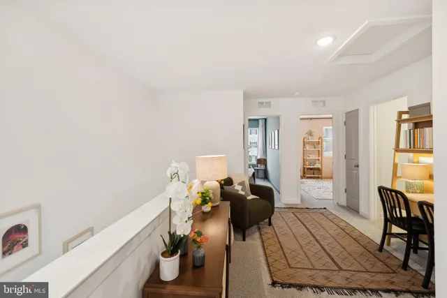 a view of a bedroom with furniture and a window
