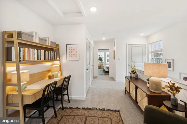 a living room with furniture and a book shelf
