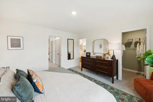 a bedroom with a bed and a dresser