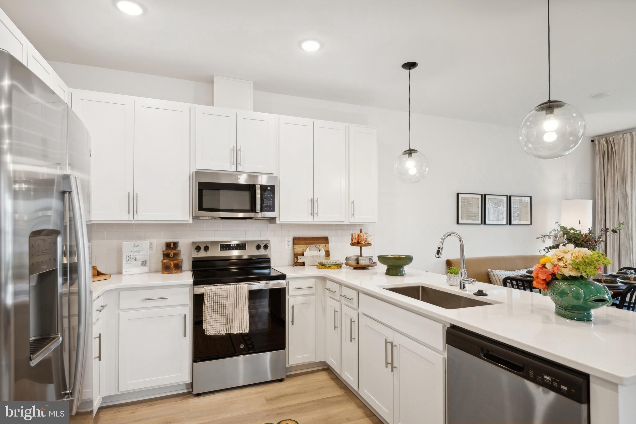 0 Cougar Lane Locust Grove, VA 22508 - Photo 7 of 30 a kitchen with stainless steel appliances a white stove top oven a sink dishwasher and a refrigerator with wooden floor