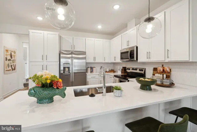 a kitchen with sink a microwave and cabinets