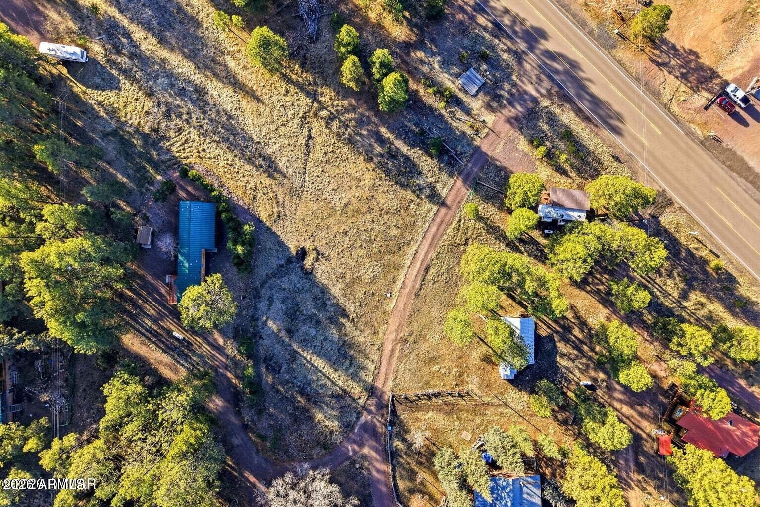 2 North County Road Alpine, AZ 85920 - Photo 16 of 16 a backyard of a house with lots of green space