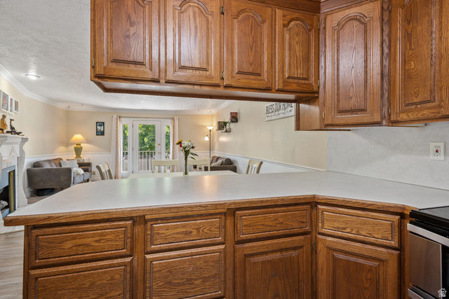 553 North 200 West Bountiful, UT 84010 - Photo 25 of 26 Kitchen featuring wood finish cabinets, light countertops, french doors, open floor plan, and ornamental molding