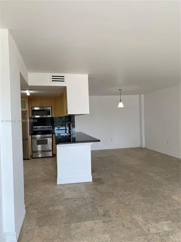 a view of kitchen with cabinets