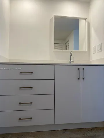 a bathroom with a sink and mirror