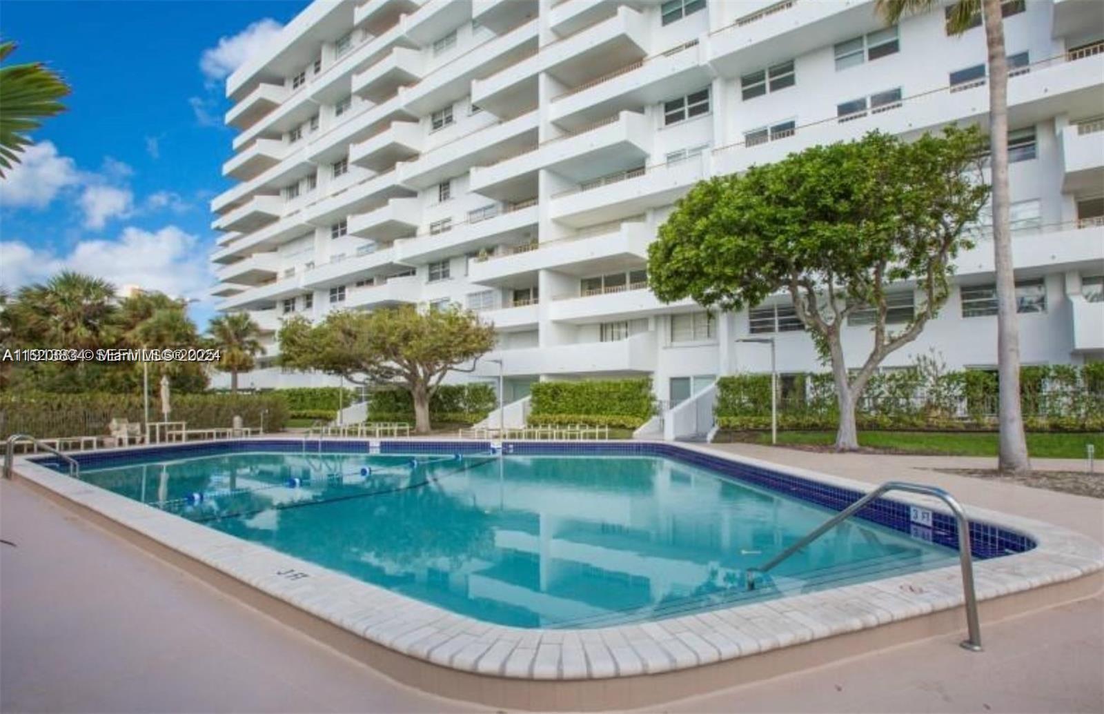 177 Ocean Ln Drive, Unit 505 Key Biscayne, FL 33149 - Photo 25 of 26 a view of a swimming pool with a garden