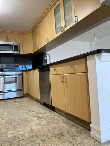 a kitchen with stainless steel appliances a refrigerator and a stove