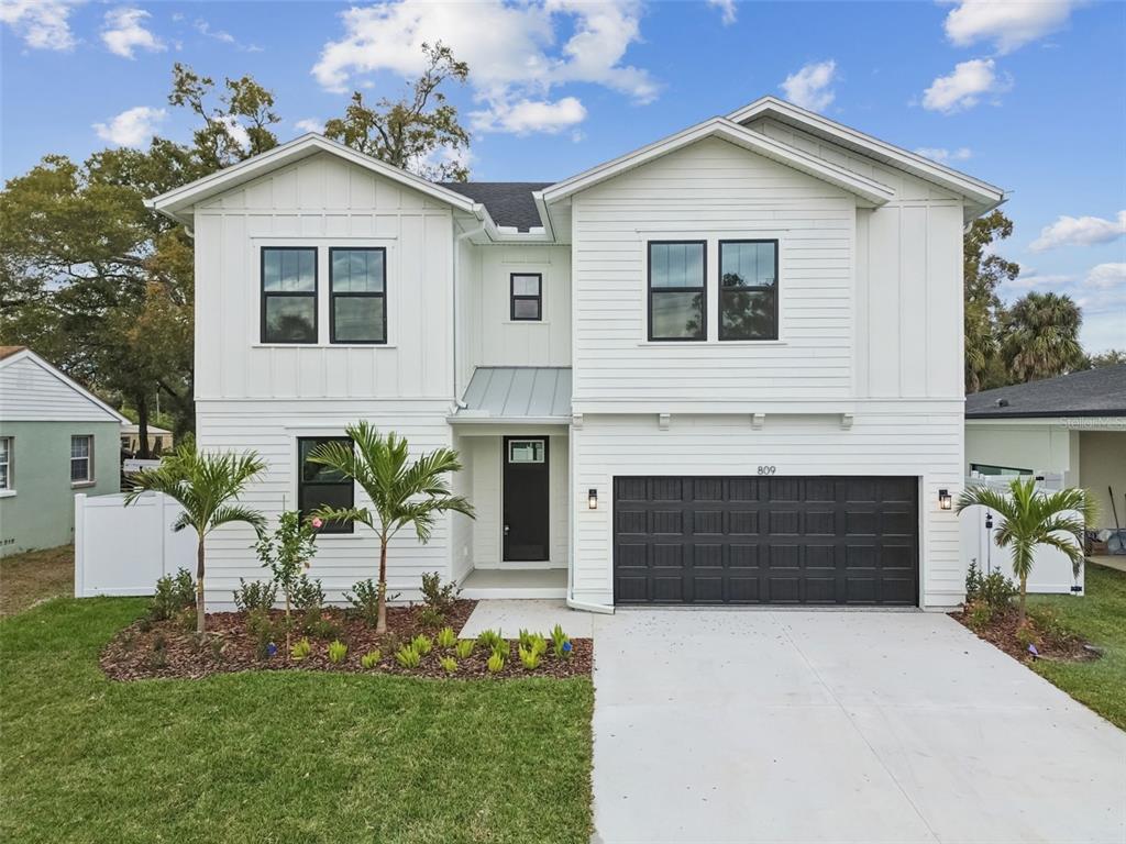 809 West Indiana Avenue Tampa, FL 33603 - Photo 1 of 64 a front view of a house with a yard and garage
