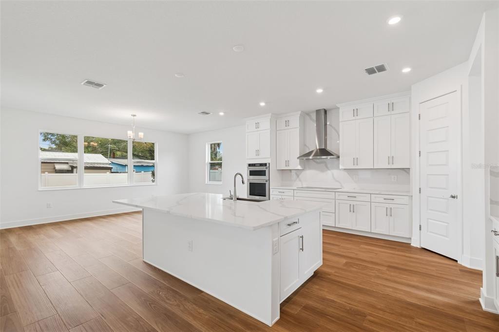 809 West Indiana Avenue Tampa, FL 33603 - Photo 27 of 64 a large kitchen with stainless steel appliances lot of white cabinets and wooden floor