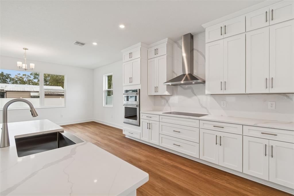 809 West Indiana Avenue Tampa, FL 33603 - Photo 30 of 64 a kitchen with stainless steel appliances a stove a sink cabinets and a wooden floor