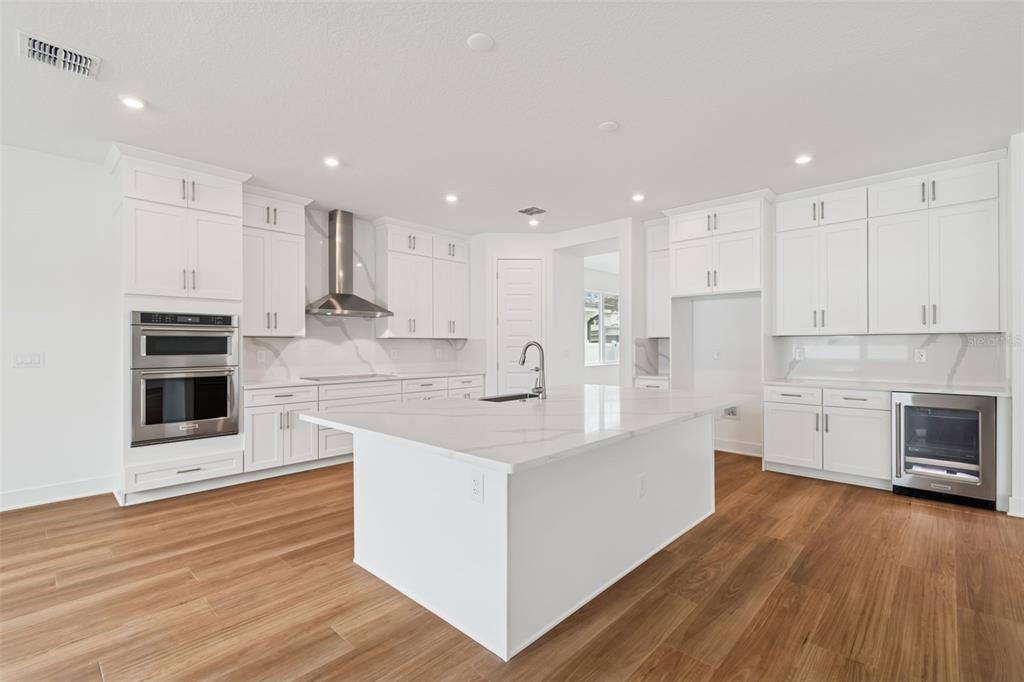 809 West Indiana Avenue Tampa, FL 33603 - Photo 3 of 64 a large kitchen with stainless steel appliances and white cabinets