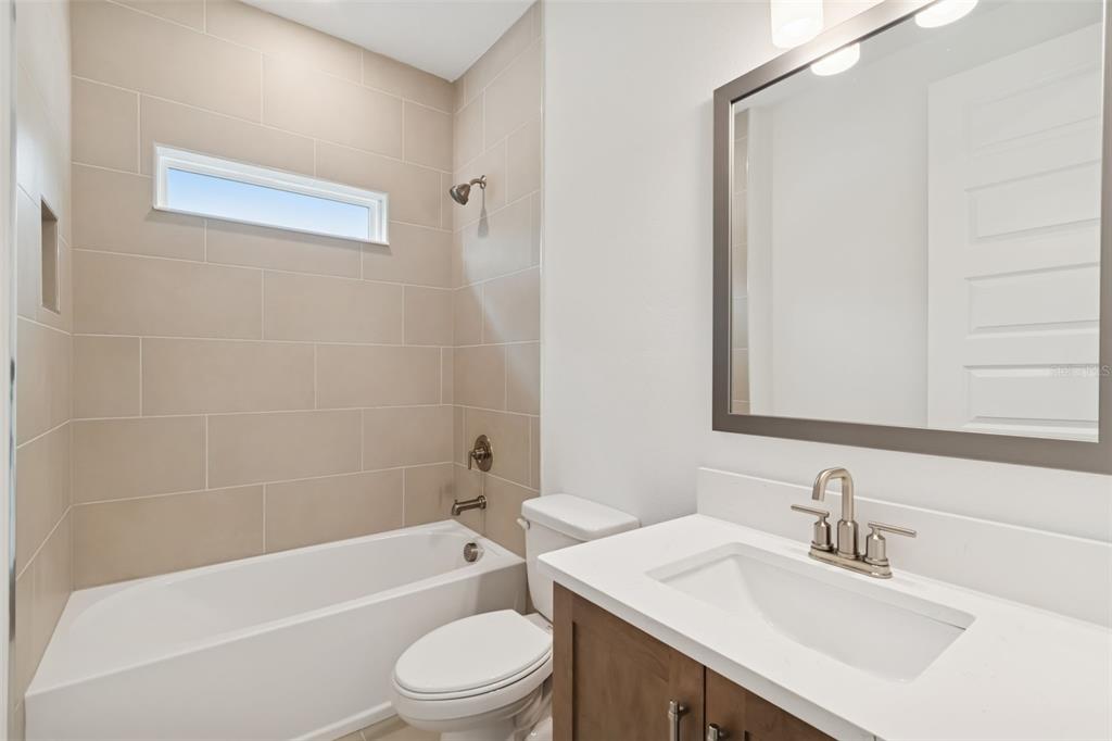 809 West Indiana Avenue Tampa, FL 33603 - Photo 56 of 64 a bathroom with a bathtub shower sink vanity mirror and toilet