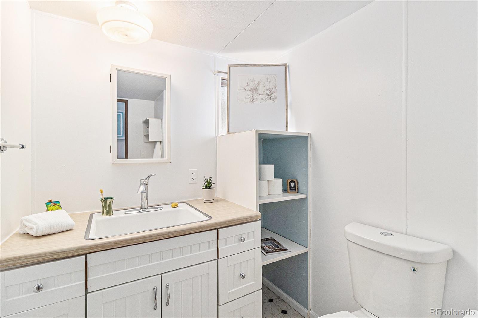 400 West South Boulder Road Louisville, CO 80027 - Photo 11 of 24 a bathroom with a sink a toilet and mirror