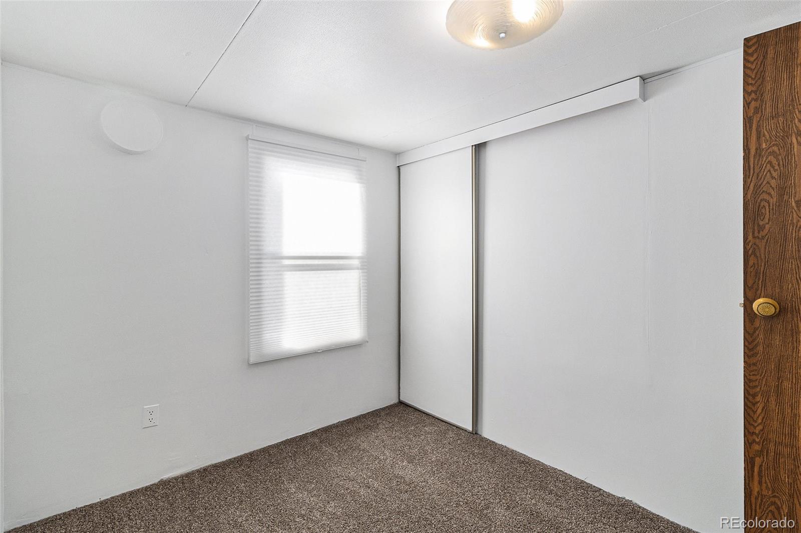 400 West South Boulder Road Louisville, CO 80027 - Photo 10 of 24 a view of an empty room with window and closet area