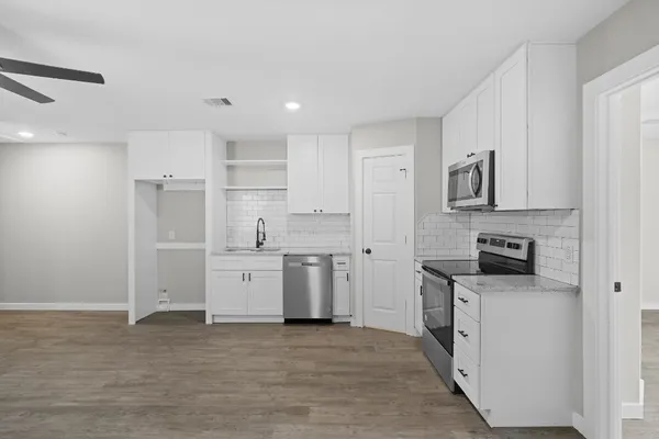 a kitchen with stainless steel appliances granite countertop a stove and a refrigerator