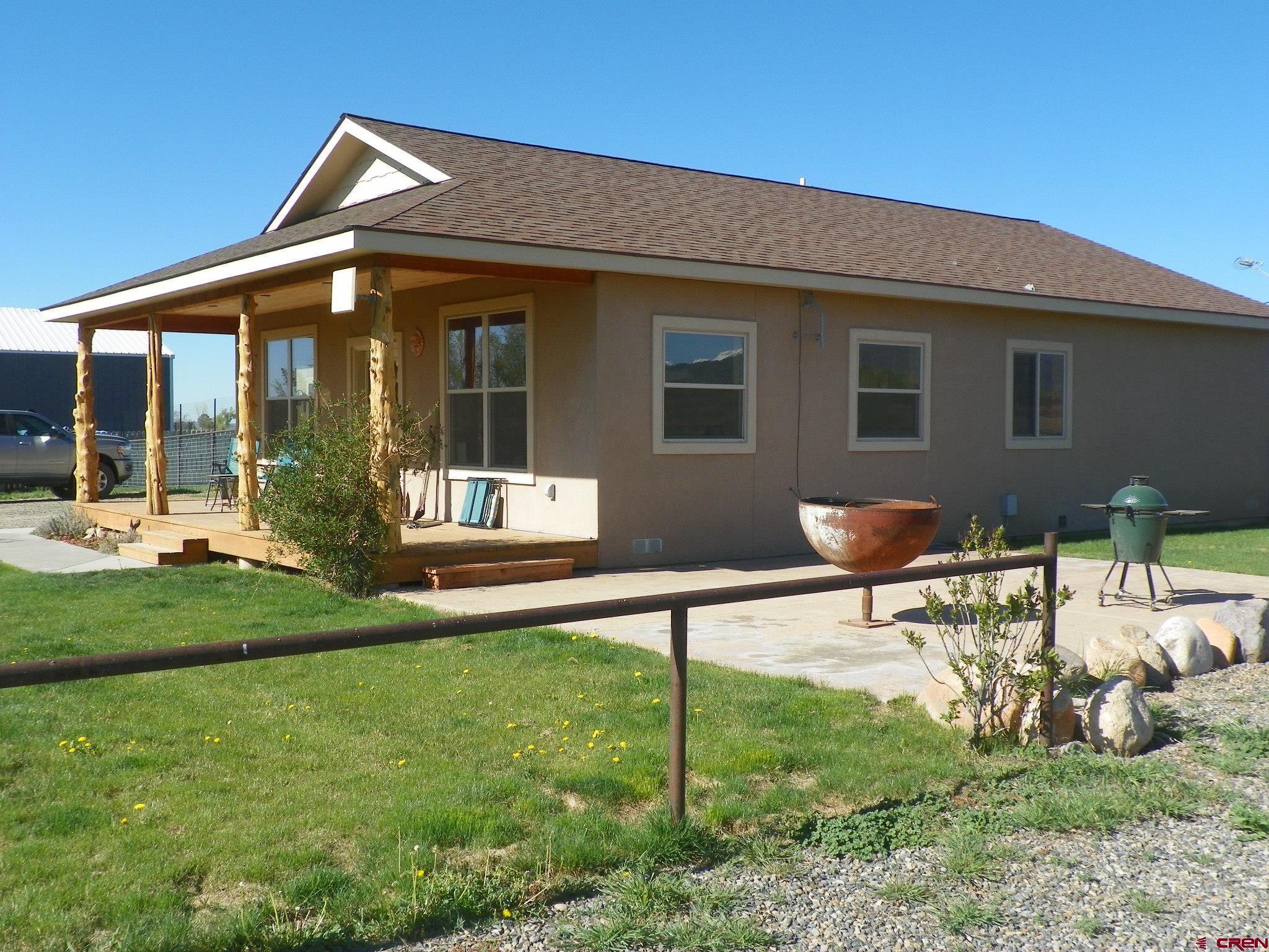 a backyard of a house with table and chairs