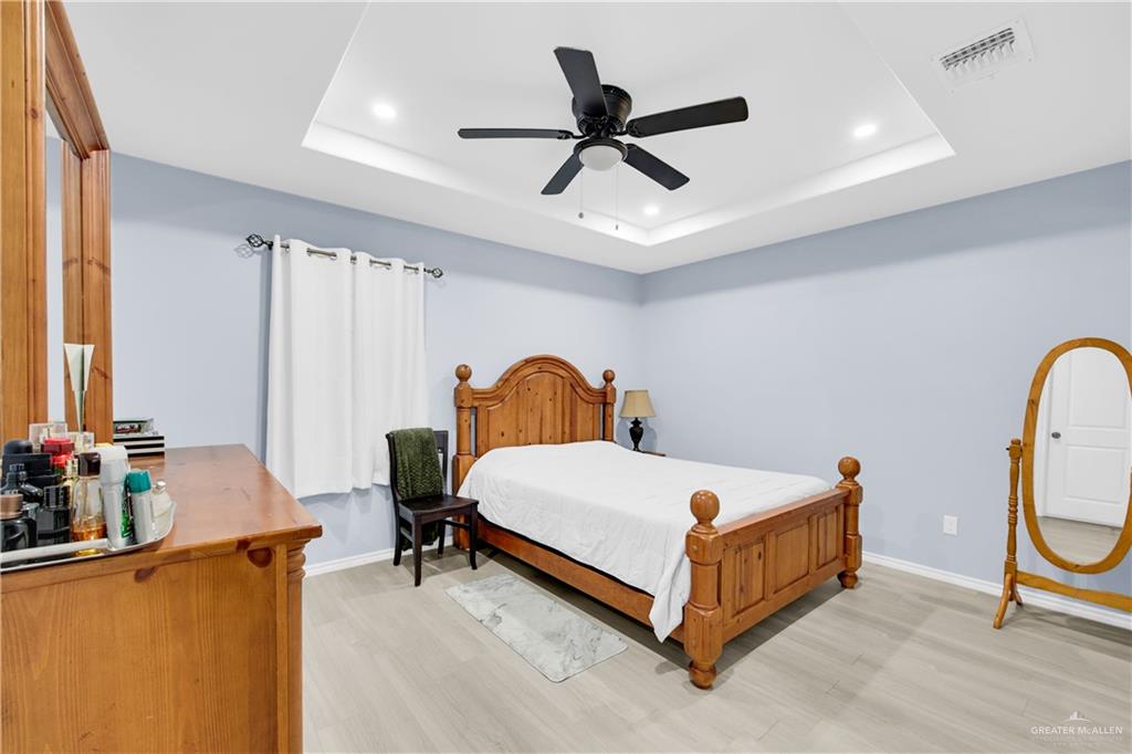 10514 Crocosmia Lane Edcouch, TX 78538 - Photo 12 of 22 a bed room with a bed and a chandelier