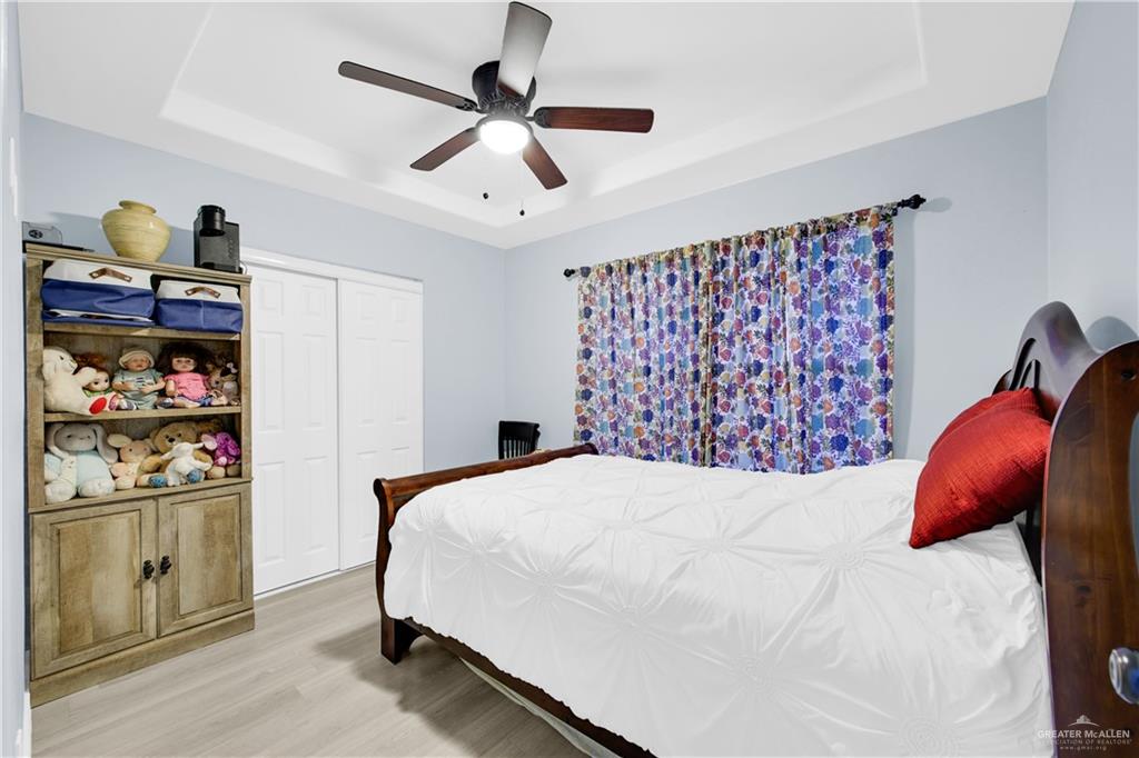 10514 Crocosmia Lane Edcouch, TX 78538 - Photo 15 of 22 a bedroom with a bed and a book shelf