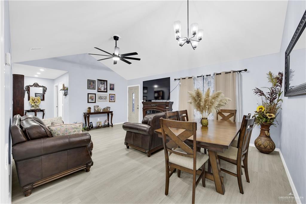 10514 Crocosmia Lane Edcouch, TX 78538 - Photo 5 of 22 a living room with furniture a chandelier and a flat screen tv