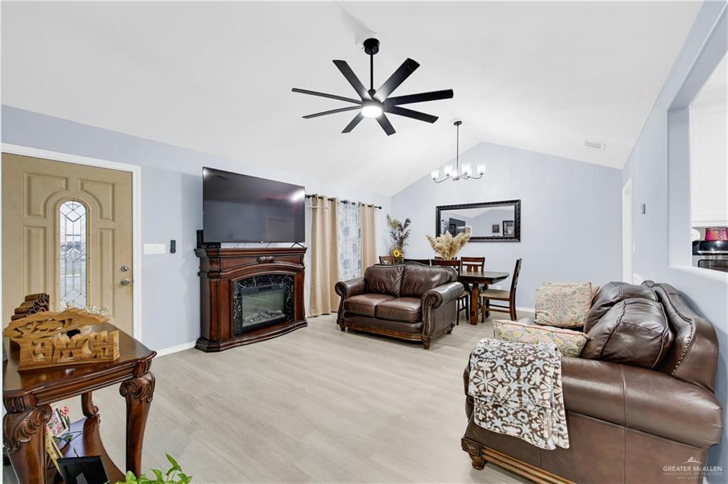 10514 Crocosmia Lane Edcouch, TX 78538 - Photo 7 of 22 a living room with furniture a fireplace and a flat screen tv