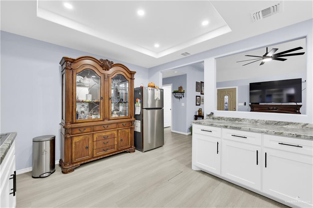 10514 Crocosmia Lane Edcouch, TX 78538 - Photo 8 of 22 a spacious bathroom with a granite countertop sink and a mirror