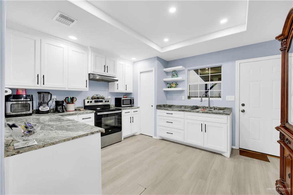 10514 Crocosmia Lane Edcouch, TX 78538 - Photo 9 of 22 a kitchen with granite countertop white cabinets and stainless steel appliances