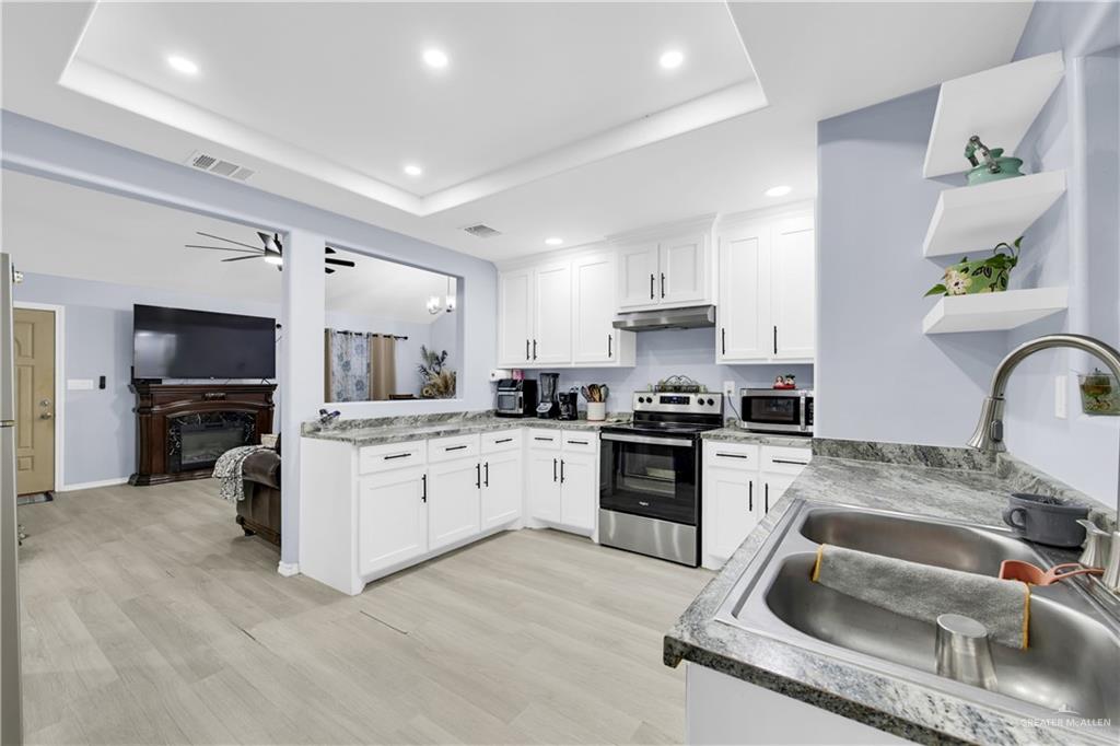 10514 Crocosmia Lane Edcouch, TX 78538 - Photo 10 of 22 a kitchen with white cabinets and stainless steel appliances