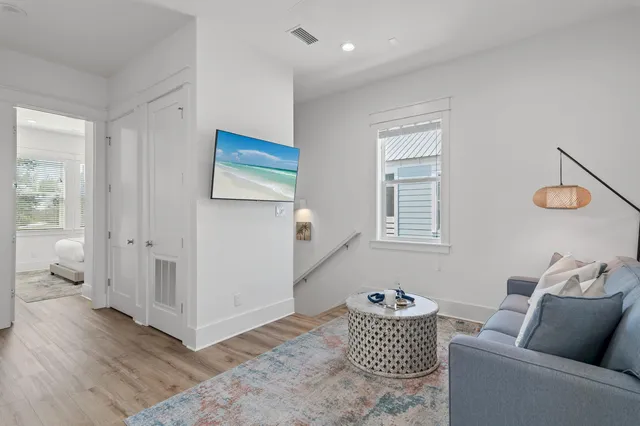 a living room with furniture and wooden floor