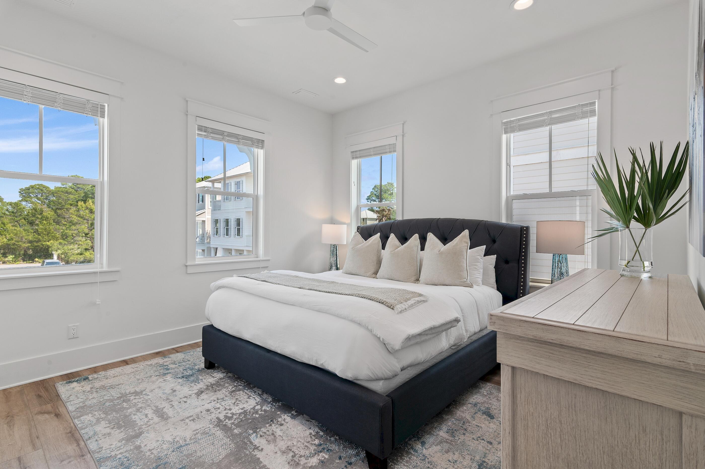 63 Sawgrass Lane Santa Rosa Beach, FL 32459 - Photo 19 of 51 a large white bed sitting in a bedroom next to a window