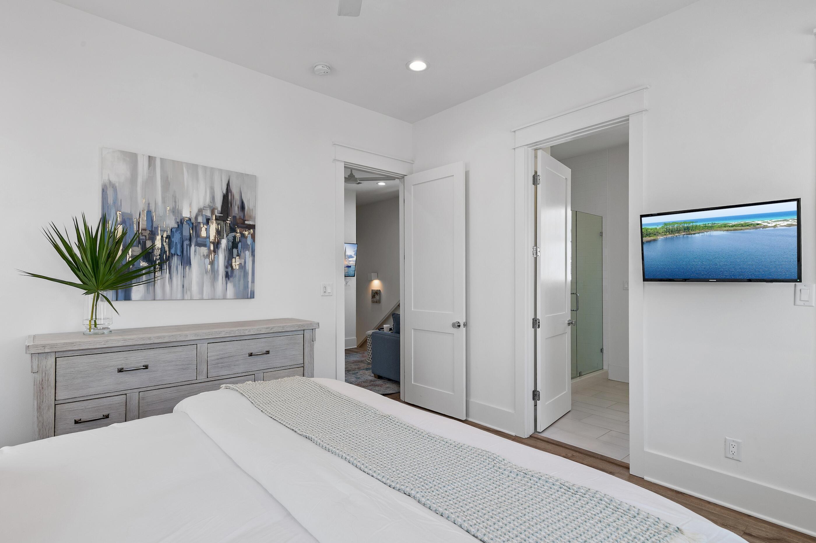 63 Sawgrass Lane Santa Rosa Beach, FL 32459 - Photo 21 of 51 a bedroom with a large bed and a potted plant