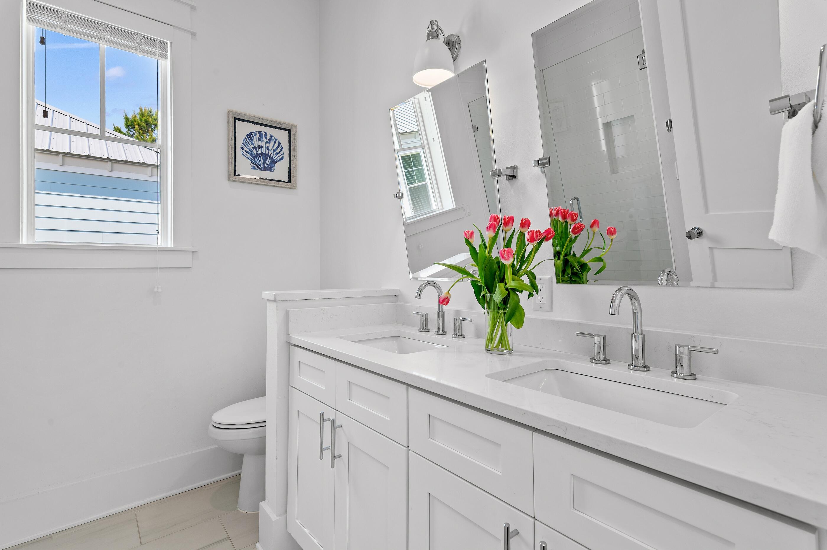 63 Sawgrass Lane Santa Rosa Beach, FL 32459 - Photo 22 of 51 a bathroom with a granite countertop sink a large mirror and a shower