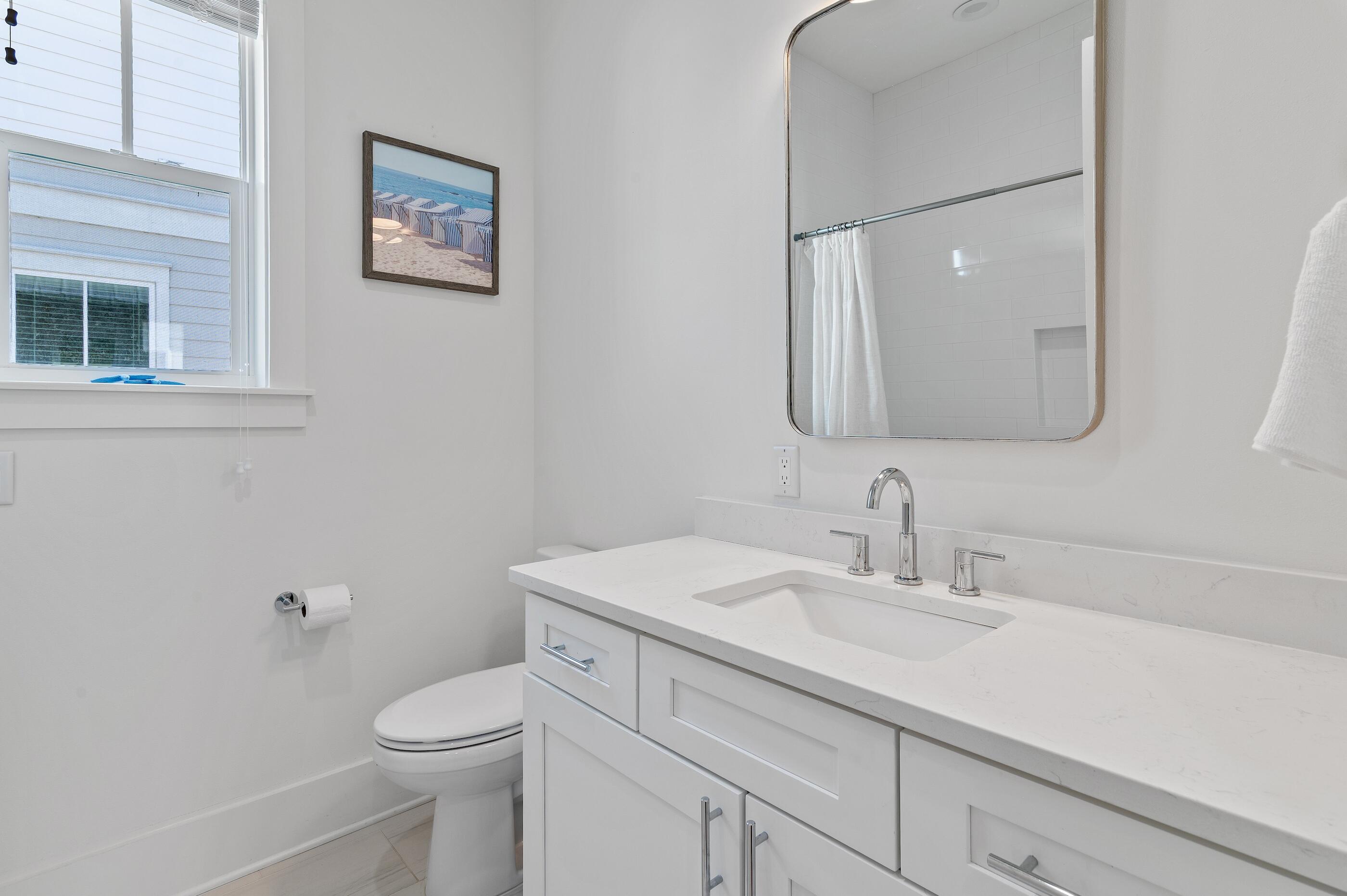 63 Sawgrass Lane Santa Rosa Beach, FL 32459 - Photo 29 of 51 a bathroom with a toilet a sink and mirror