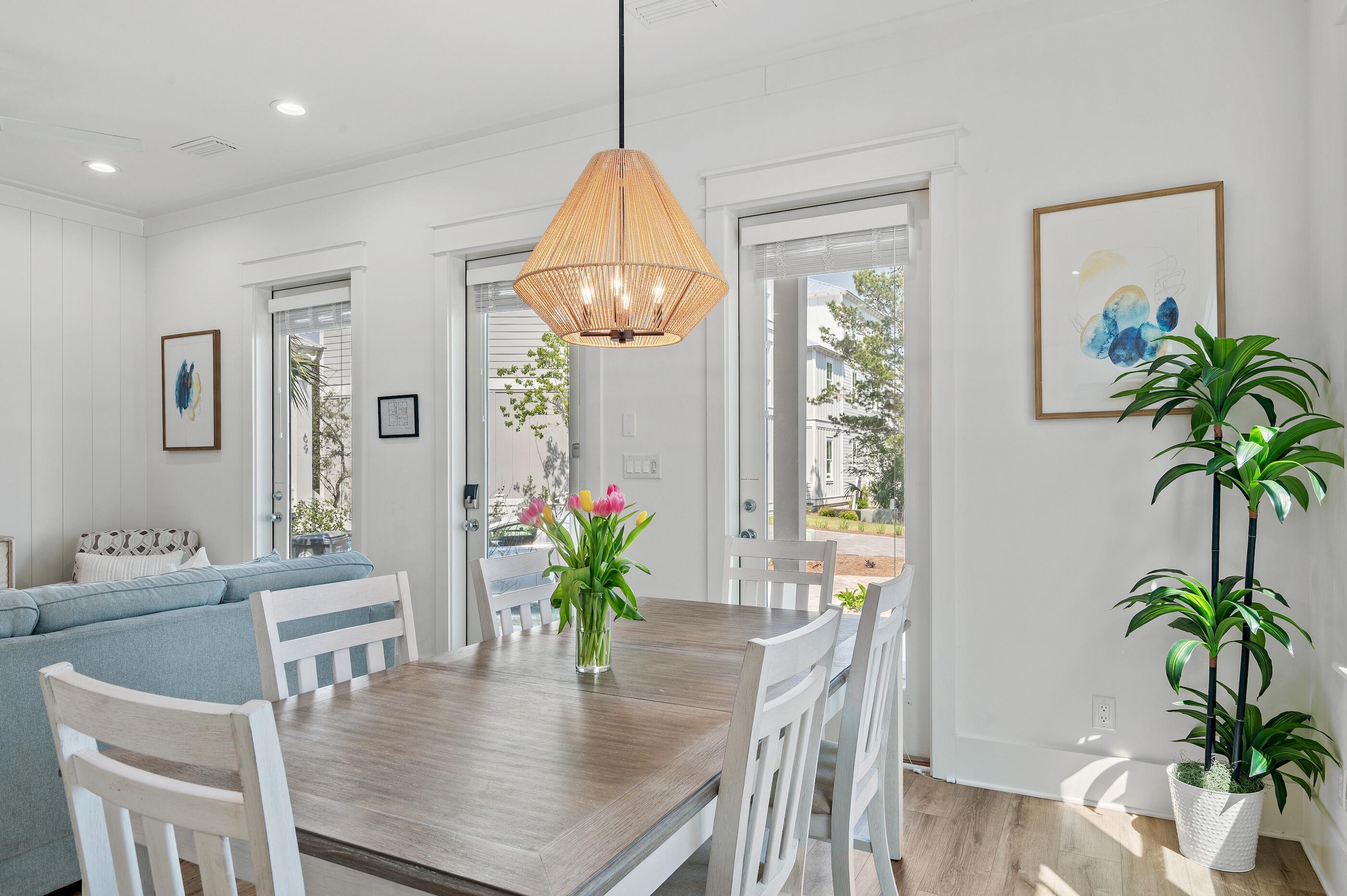 63 Sawgrass Lane Santa Rosa Beach, FL 32459 - Photo 6 of 51 a dining room with furniture a chandelier and wooden floor