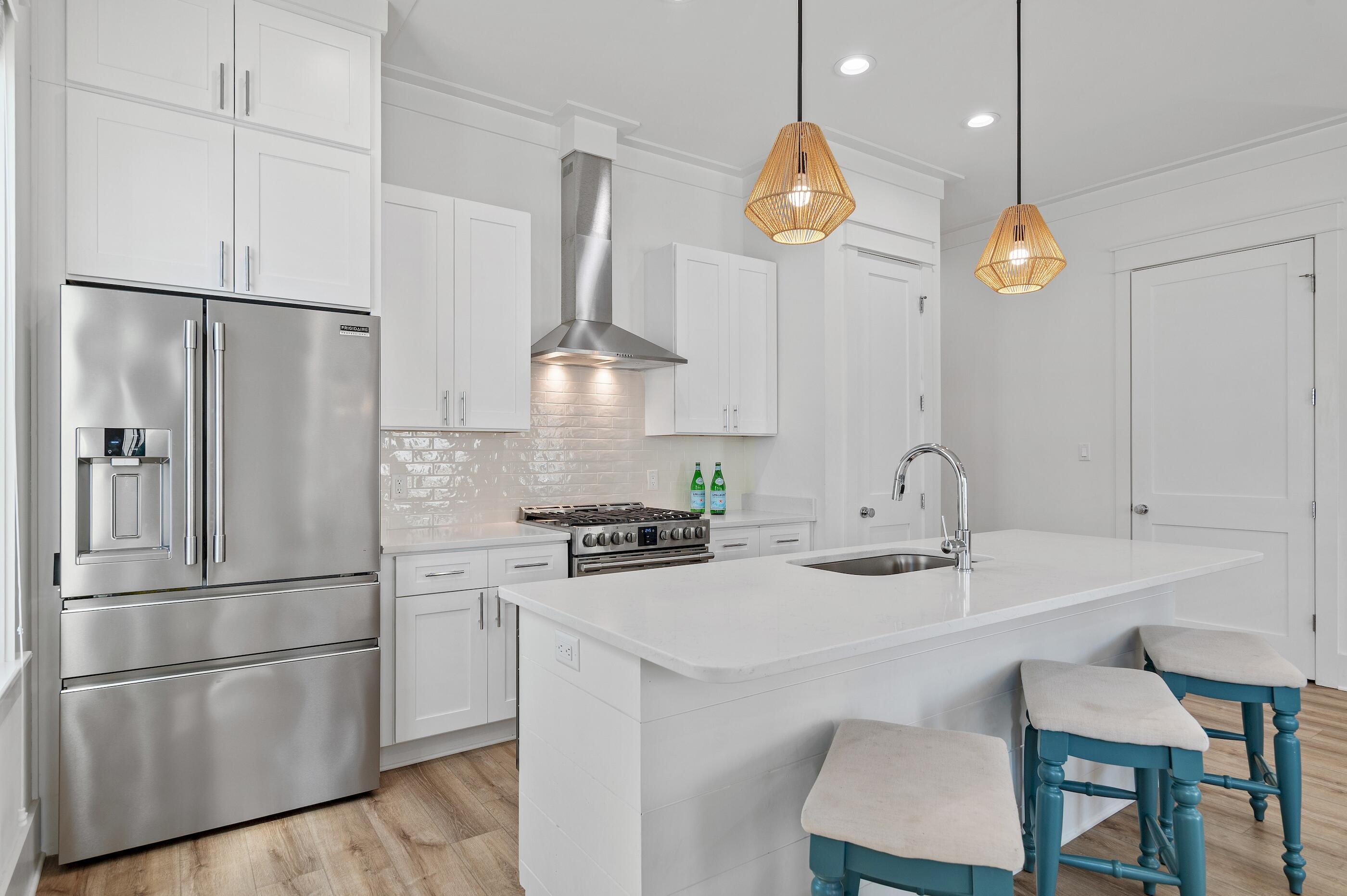 63 Sawgrass Lane Santa Rosa Beach, FL 32459 - Photo 8 of 51 a kitchen with stainless steel appliances granite countertop a sink a stove a refrigerator and cabinets