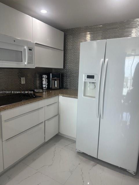 1250 South Miami Avenue, Unit 2013 Miami, FL 33130 - Photo 5 of 19 a kitchen with stainless steel appliances a refrigerator a sink and white cabinets