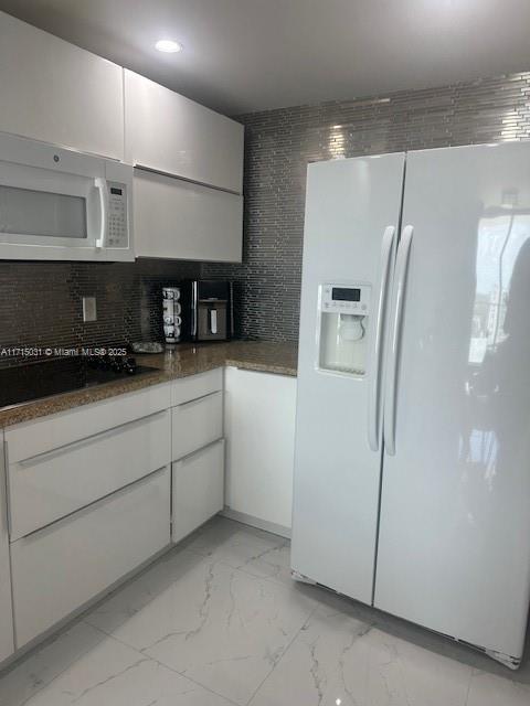 1250 South Miami Avenue, Unit 2013 Miami, FL 33130 - Photo 6 of 19 a kitchen with stainless steel appliances a refrigerator a sink and white cabinets