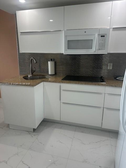 1250 South Miami Avenue, Unit 2013 Miami, FL 33130 - Photo 7 of 19 a kitchen with stainless steel appliances a sink and cabinets