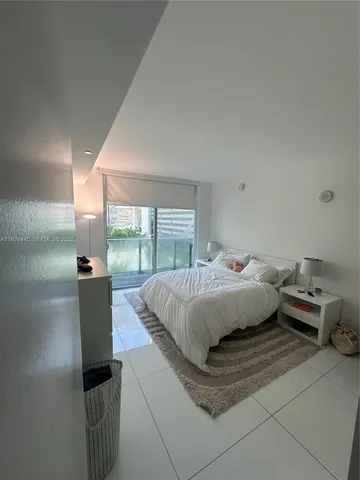 a room with a bed and a wooden floor