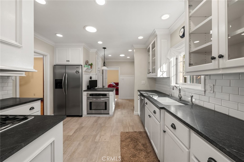 3754 California Long Beach, CA 90807 - Photo 11 of 38 a kitchen with stainless steel appliances granite countertop a sink stove and refrigerator
