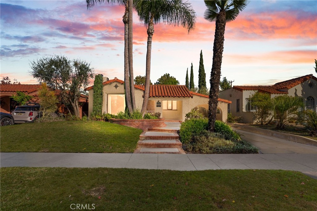 3754 California Long Beach, CA 90807 - Photo 2 of 38 a front view of multi story residential apartment building with a yard and palm trees
